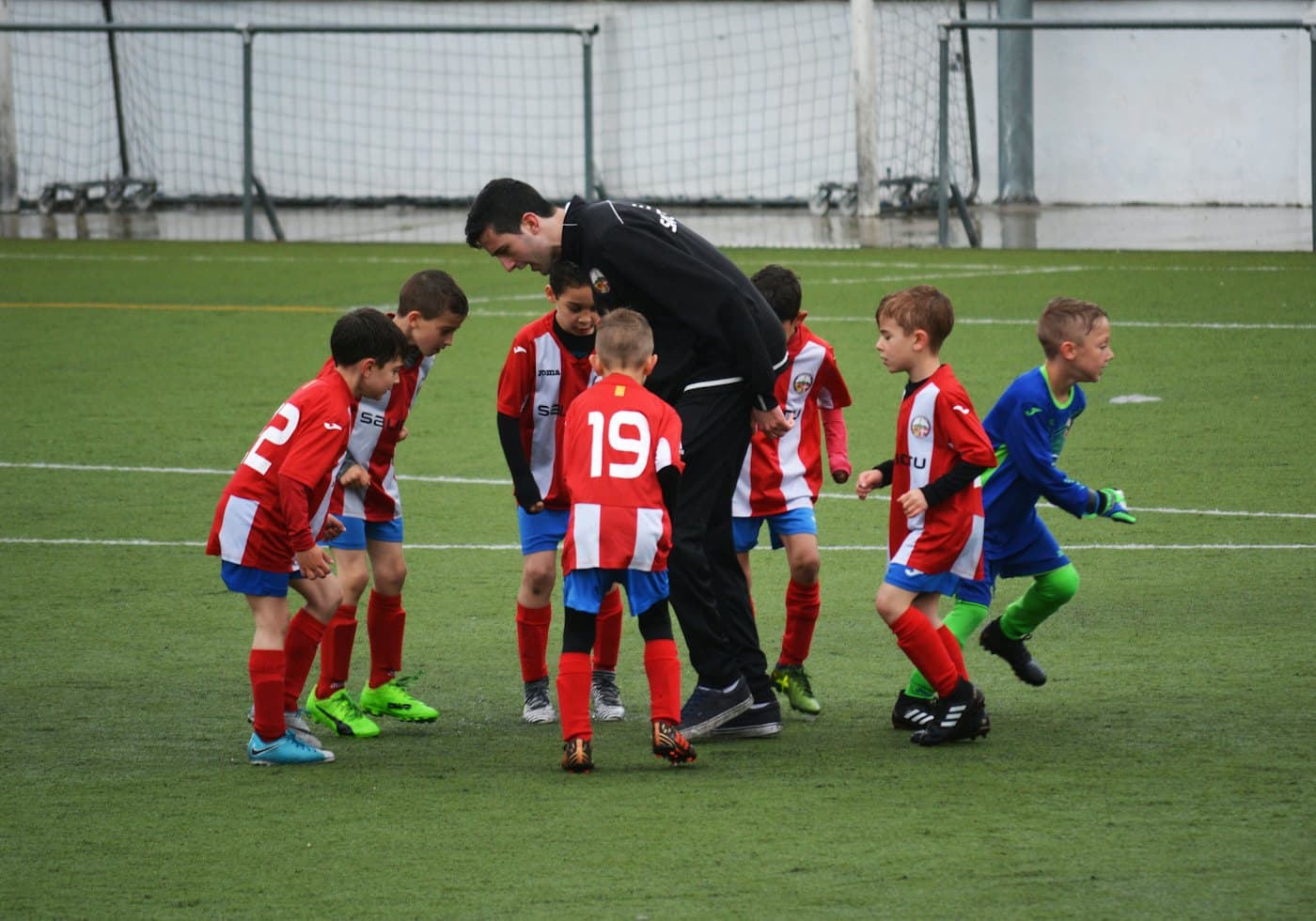A coach leading a junior football session